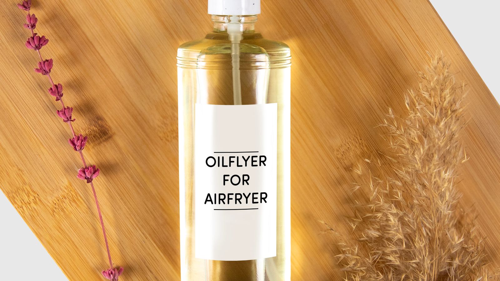 Glass oil sprayer used to lightly coat air fryer accessories before cooking