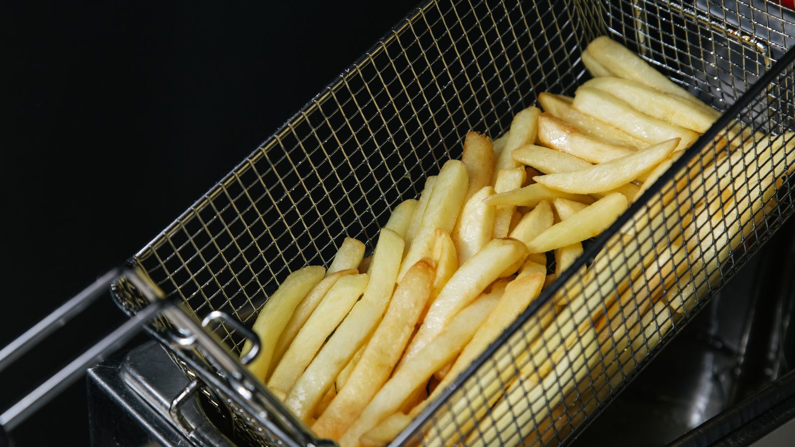 Two servings of crispy fries in an air fryer basket