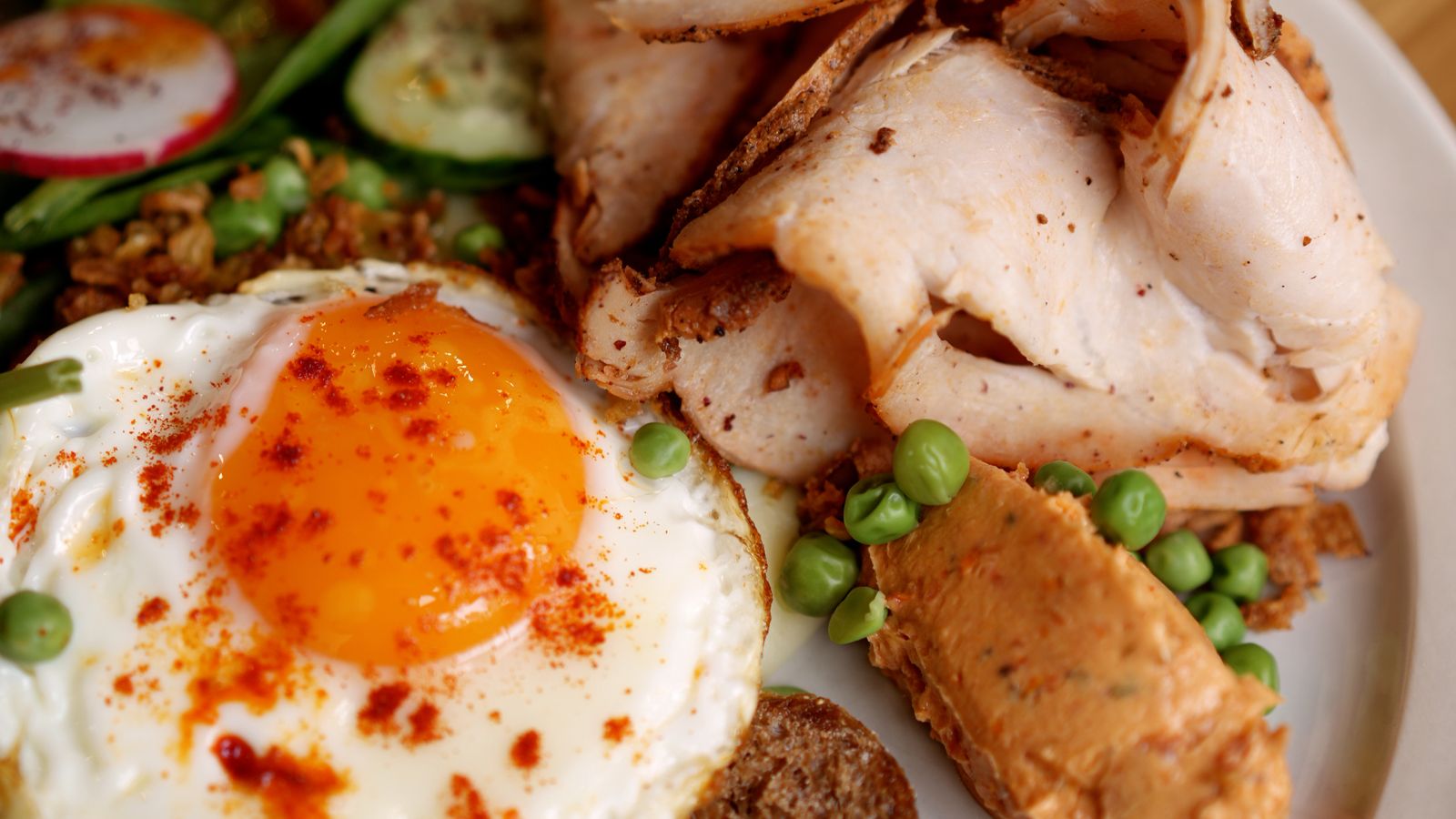 Sliced turkey breast cooked in an air fryer resting on a cutting board