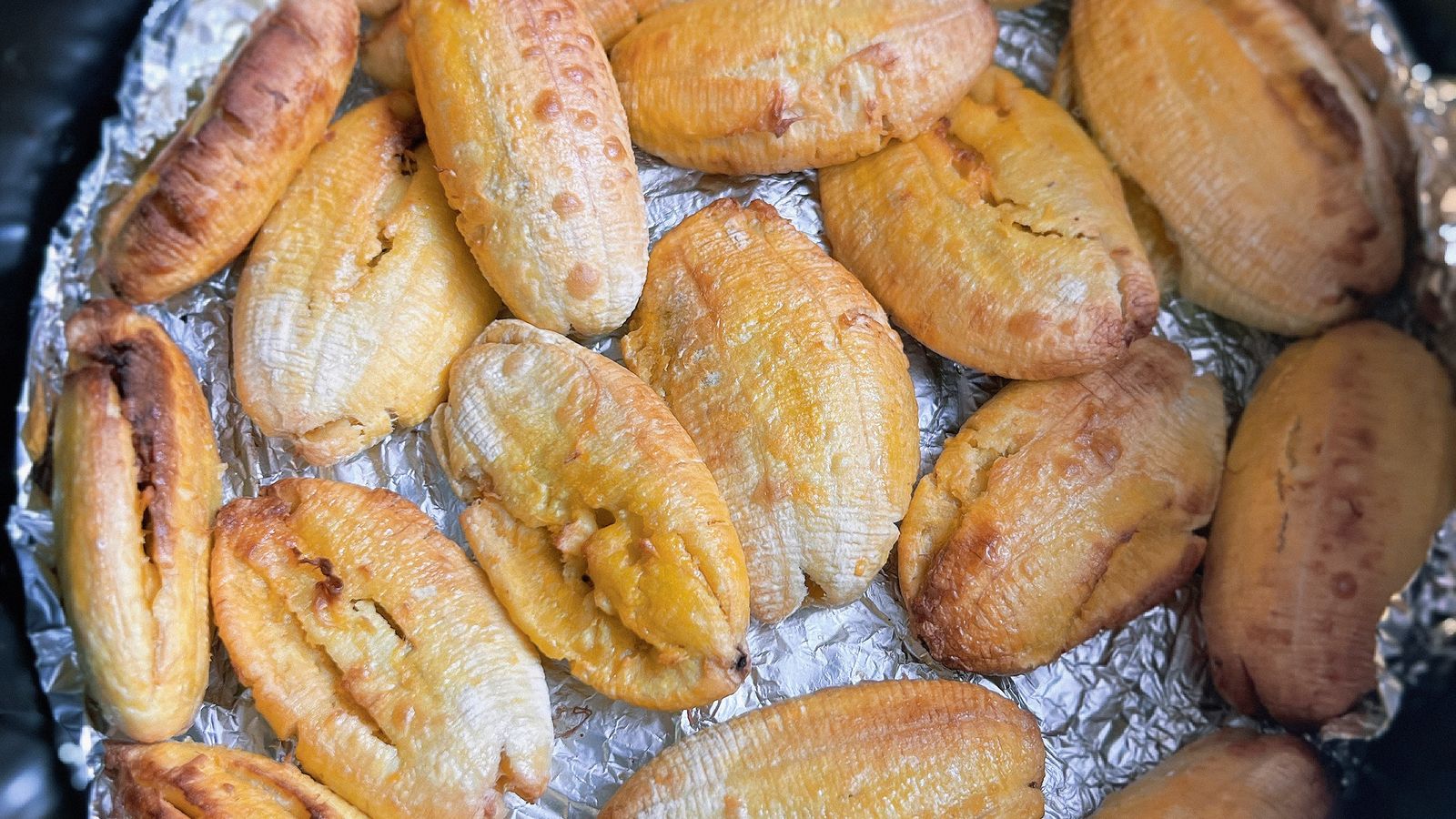 Chicken and vegetables cooking together in two separate air fryer baskets