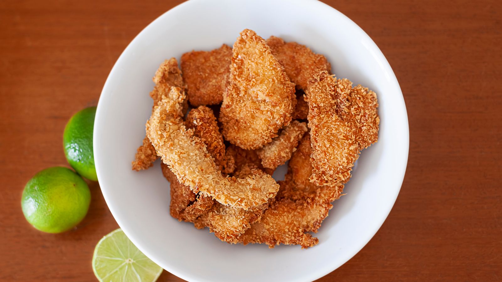 Breaded chicken cutlets being prepared before air frying