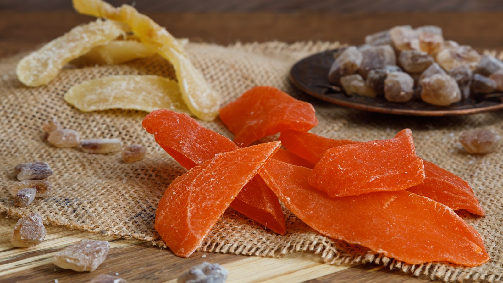 Assorted dried fruit slices spread out on a tray after dehydrating