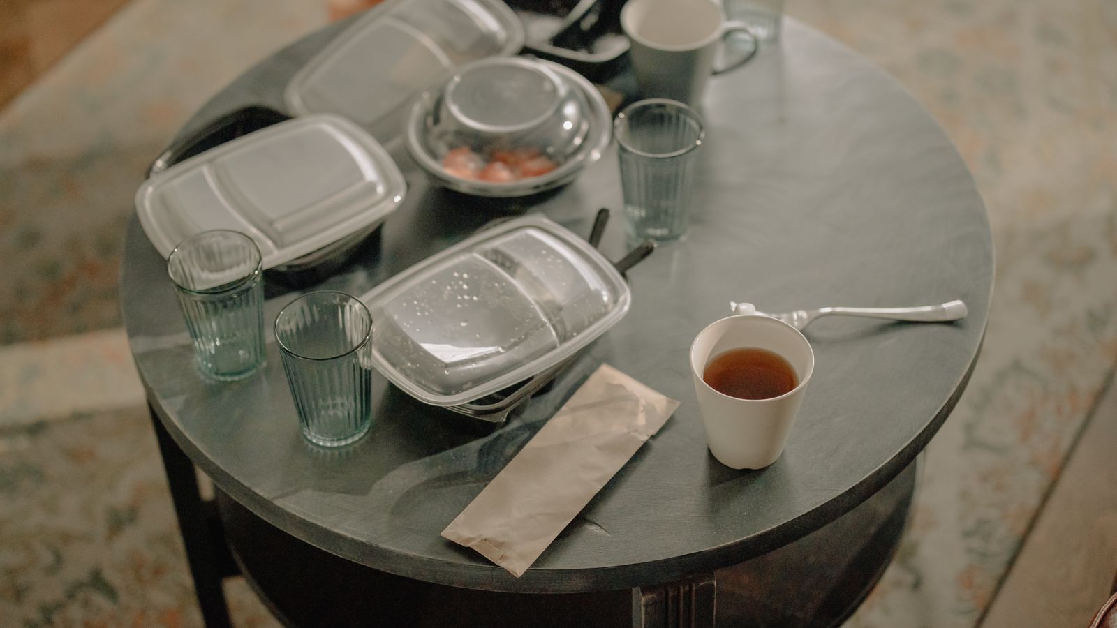 Reheated leftovers being pulled out of an air fryer basket