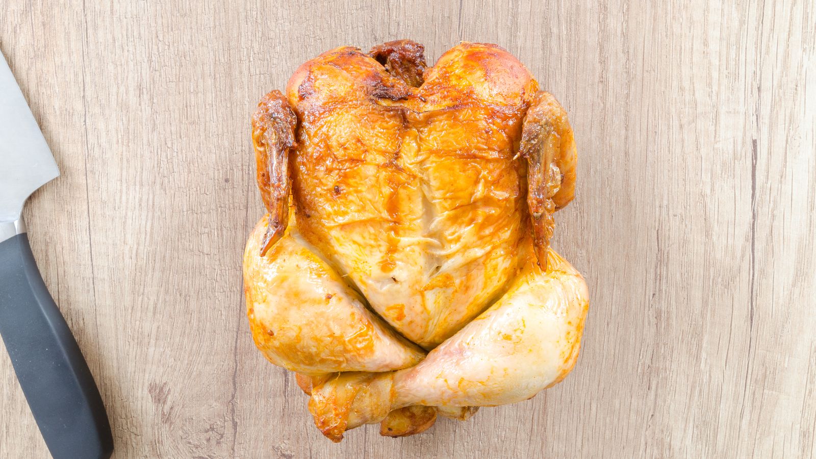 Golden roasted whole chicken resting after cooking in an air fryer