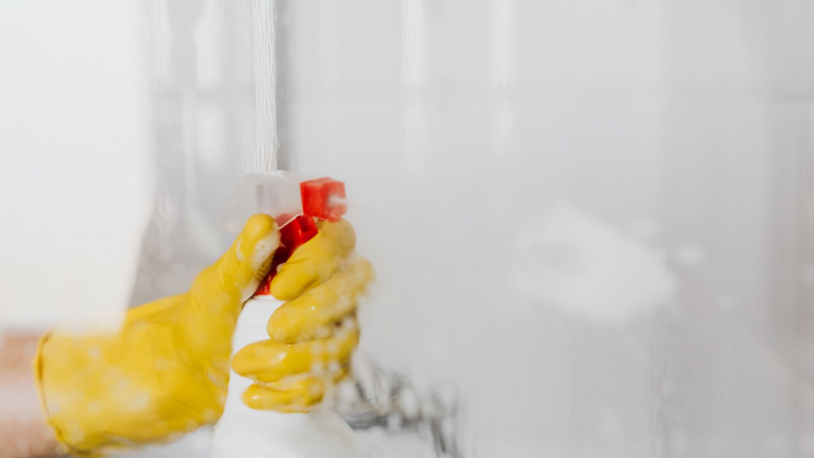 Spray bottle being used to pre-treat a fresh stain on carpet fibers