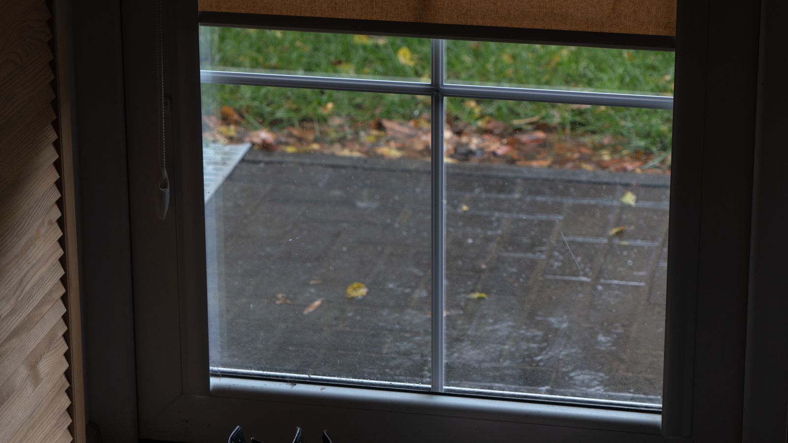 A textured doormat scraper placed at a home entrance to catch mud and debris