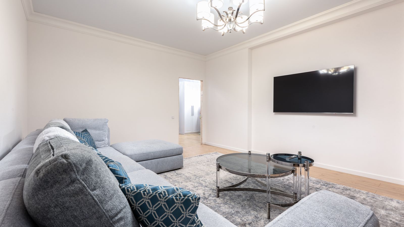 A sofa and coffee table sitting on a carpeted living room floor