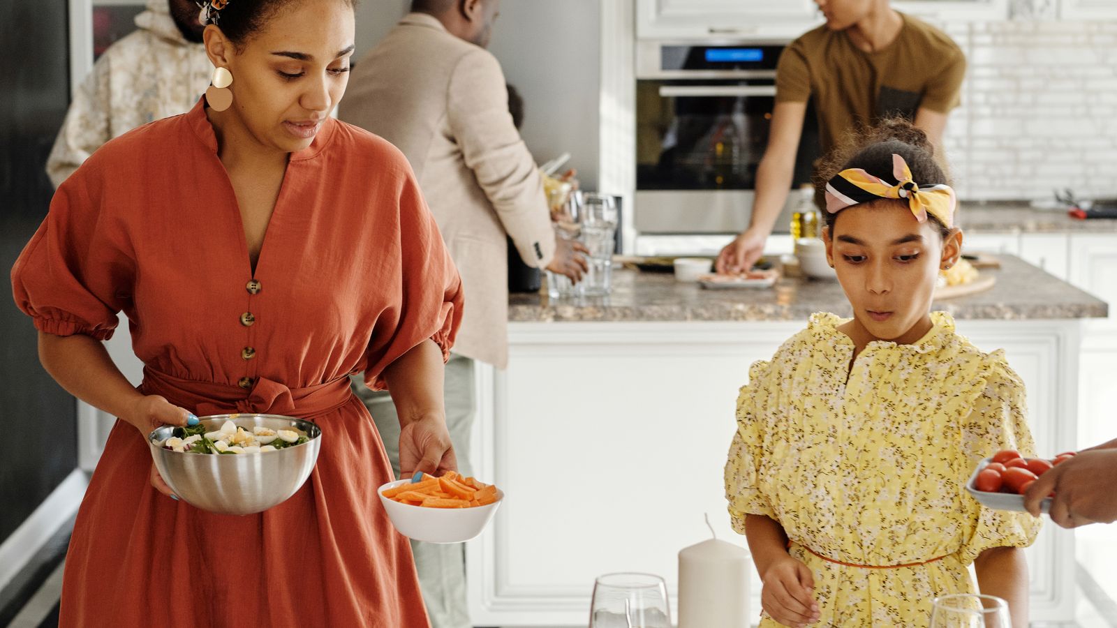 A family-sized dinner table set for six people with air-fried entrees and sides