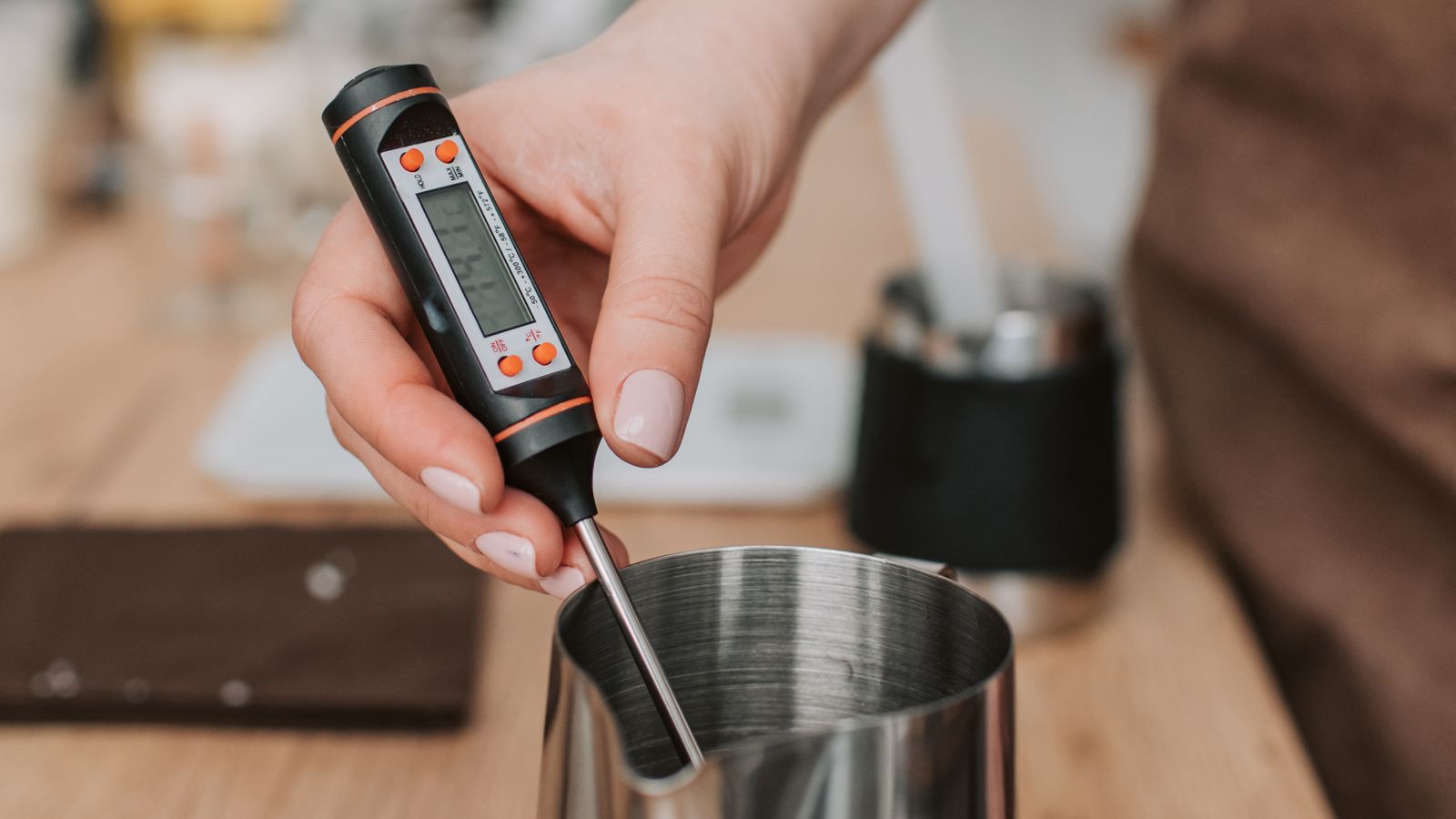 Close-up of a digital food thermometer probe being used to check temperature in a kitchen