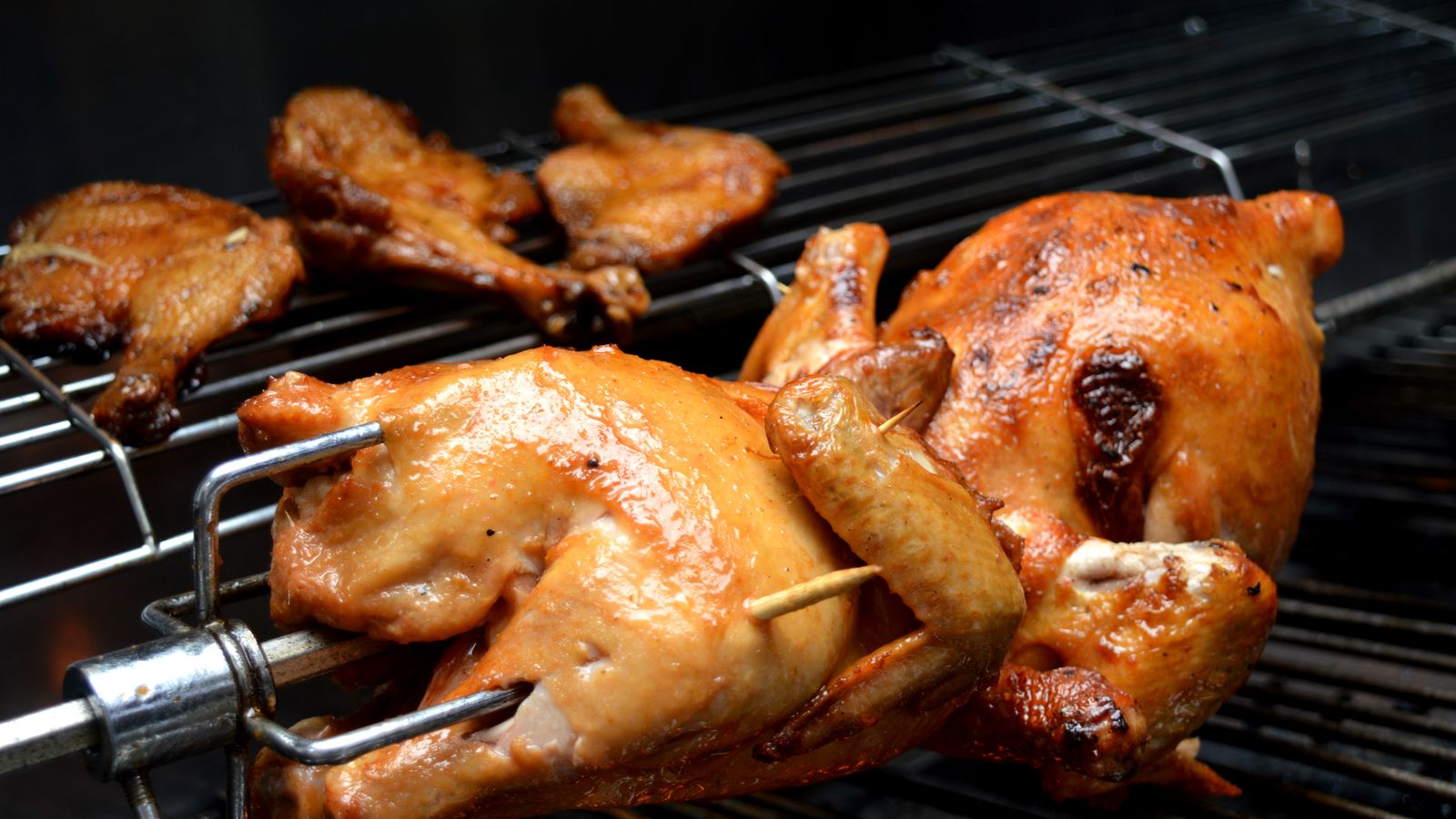 Close-up of food broiling with visible browning inside an air fryer oven