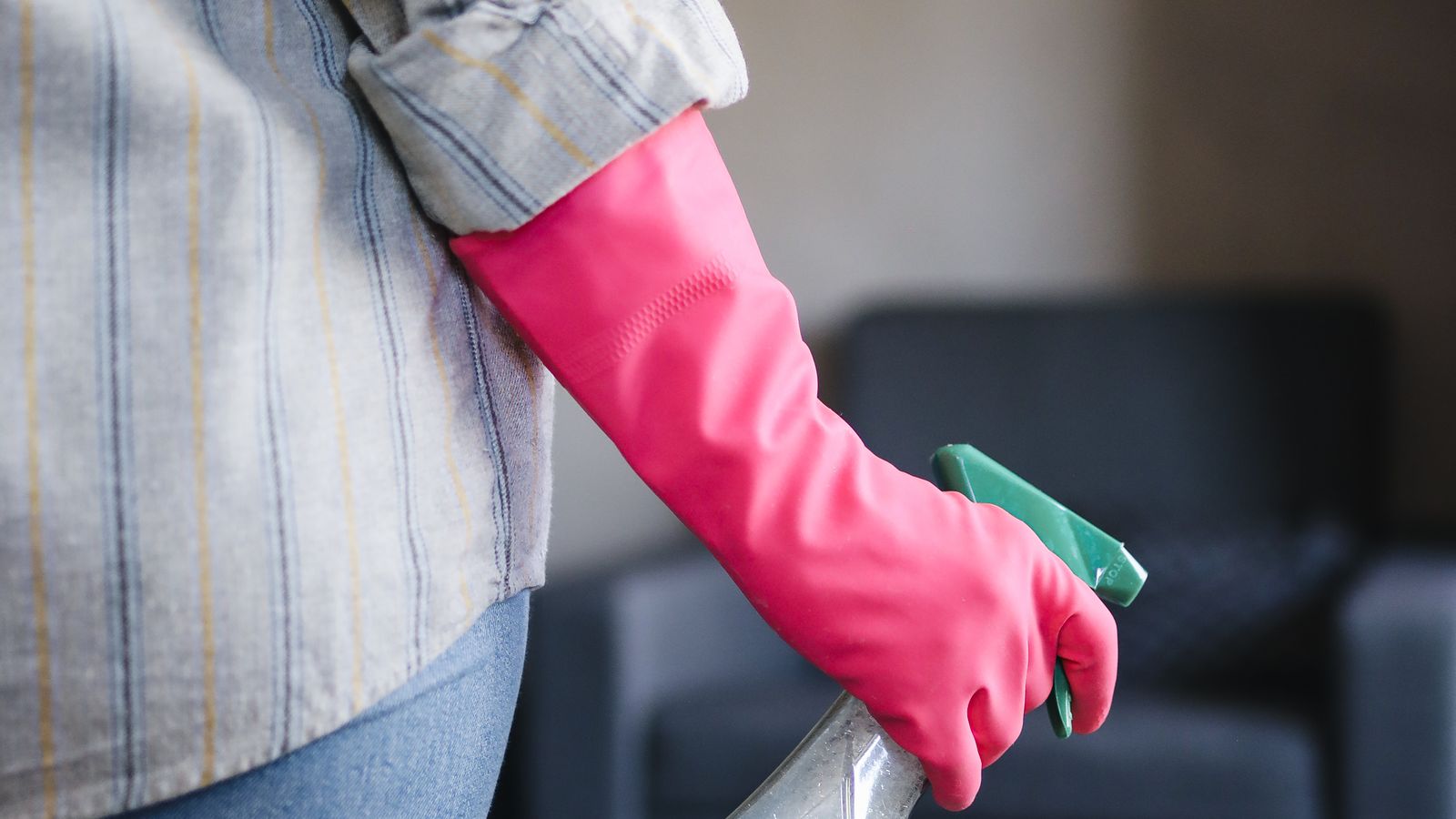 Spray bottle of carpet cleaning solution being applied to a stained rug
