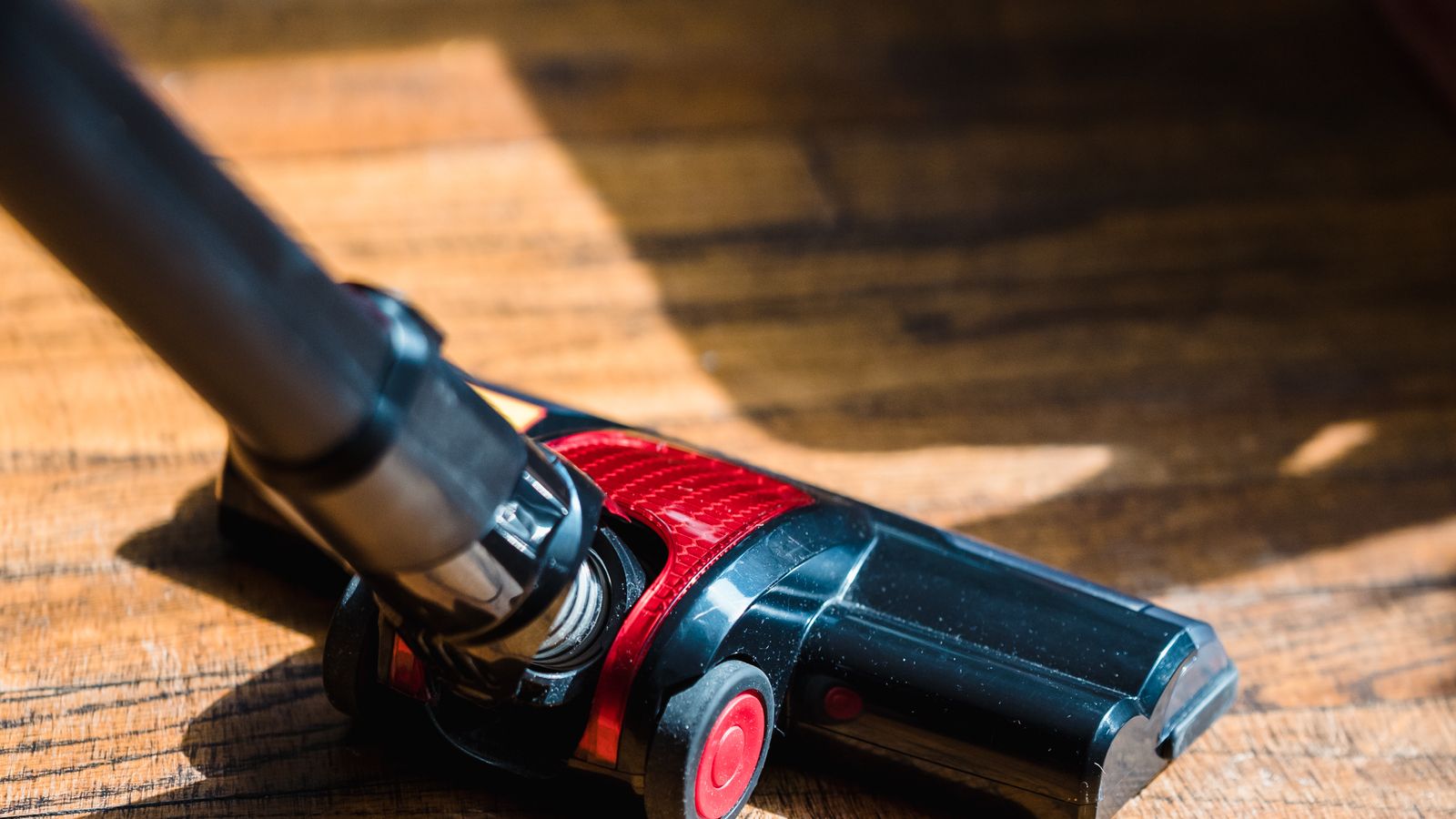 Vacuum cleaner with self-cleaning brush roll used near a kitchen counter