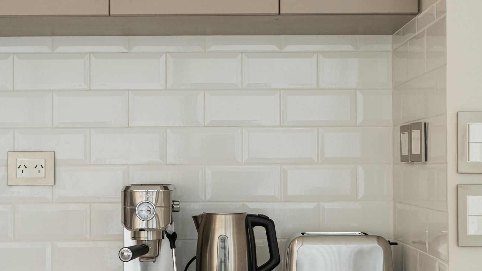 Modern countertop kitchen appliances arranged near a drawer-style air fryer