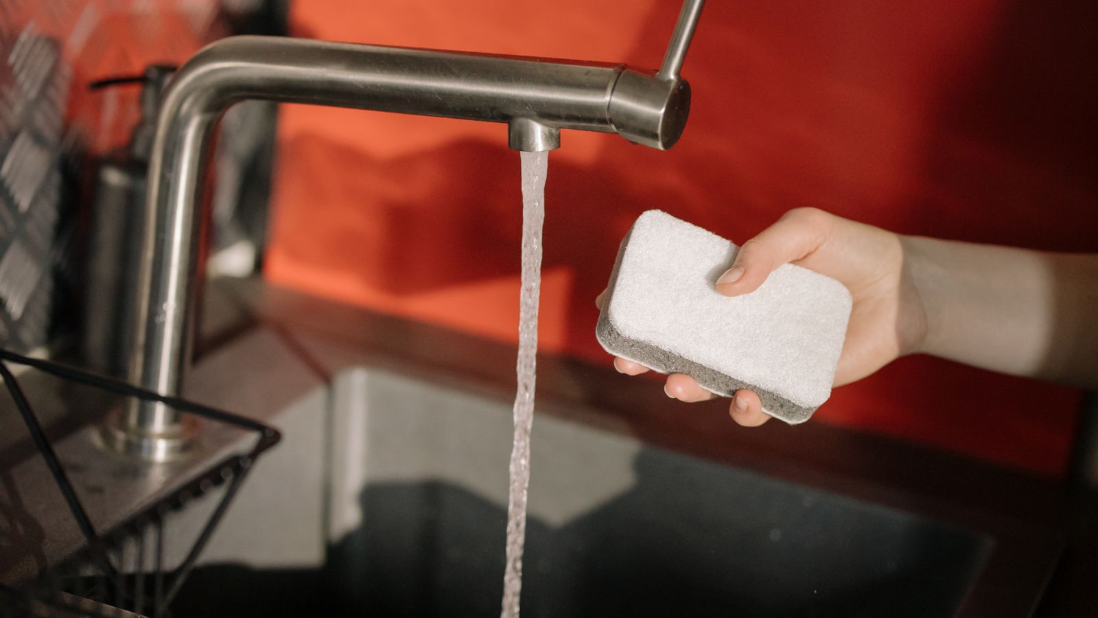 Clean kitchen counter with sponge and dish soap used for washing appliance parts