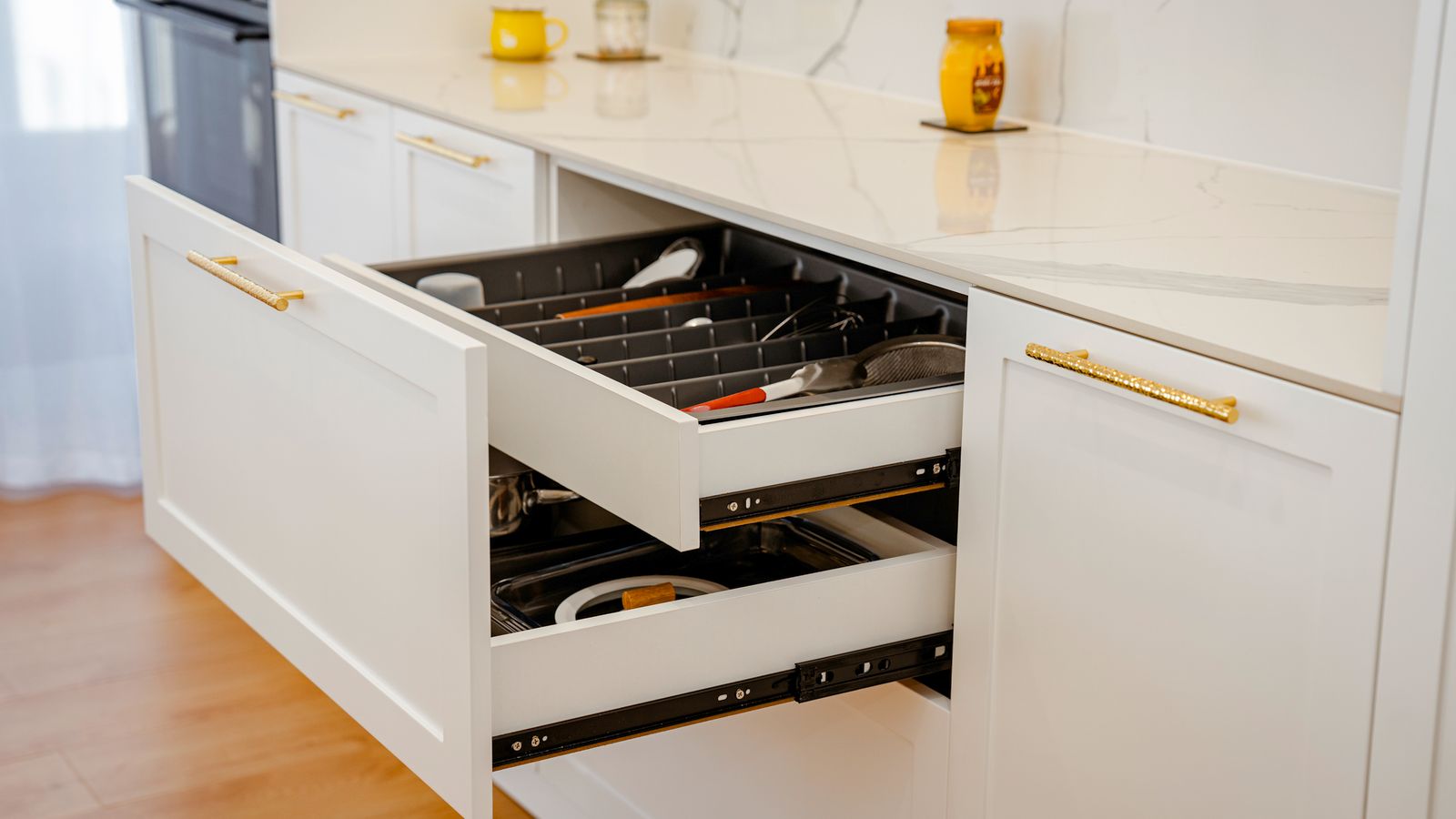 Organized kitchen drawer with air fryer accessories neatly arranged
