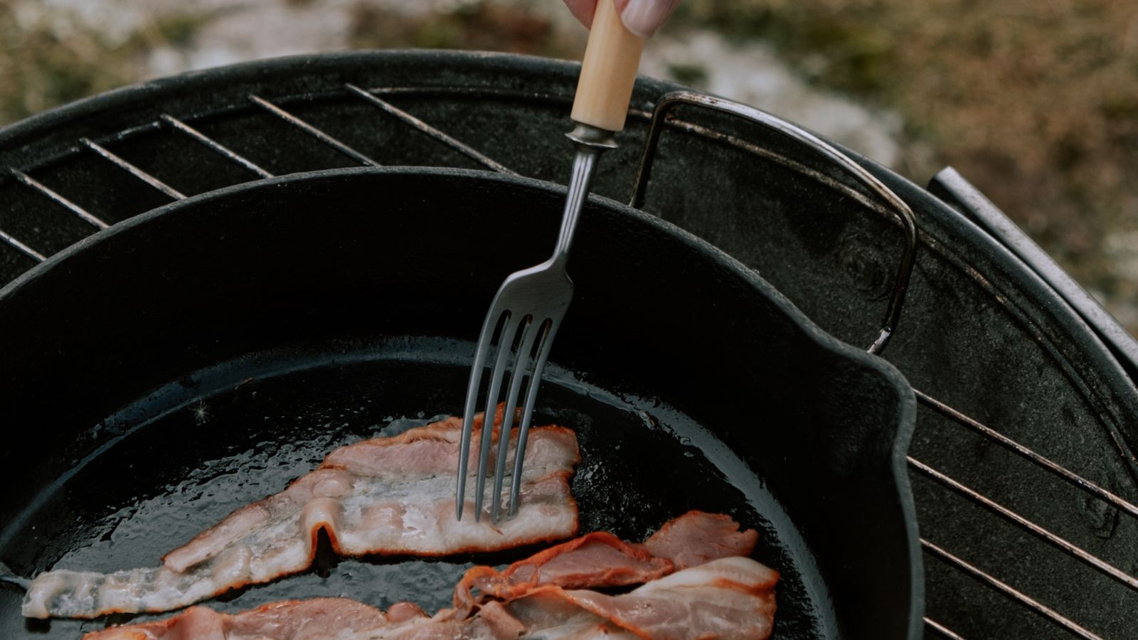 Bacon cooking in a tray, an example of a multi-use air fryer accessory