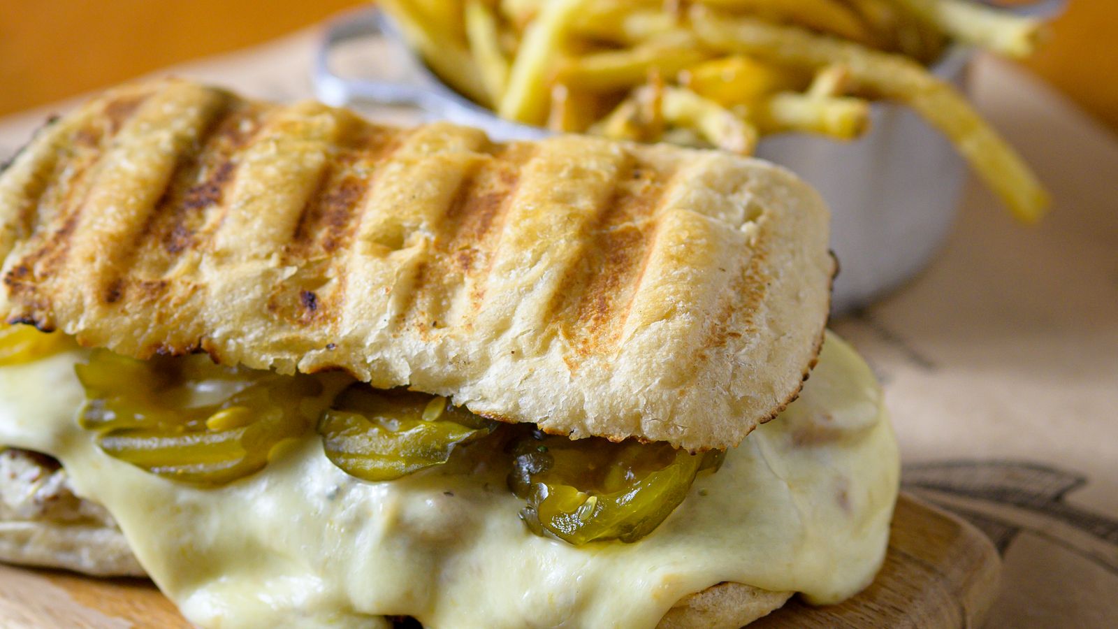 Golden grilled cheese sandwich fresh from the air fryer with crispy fries on the side