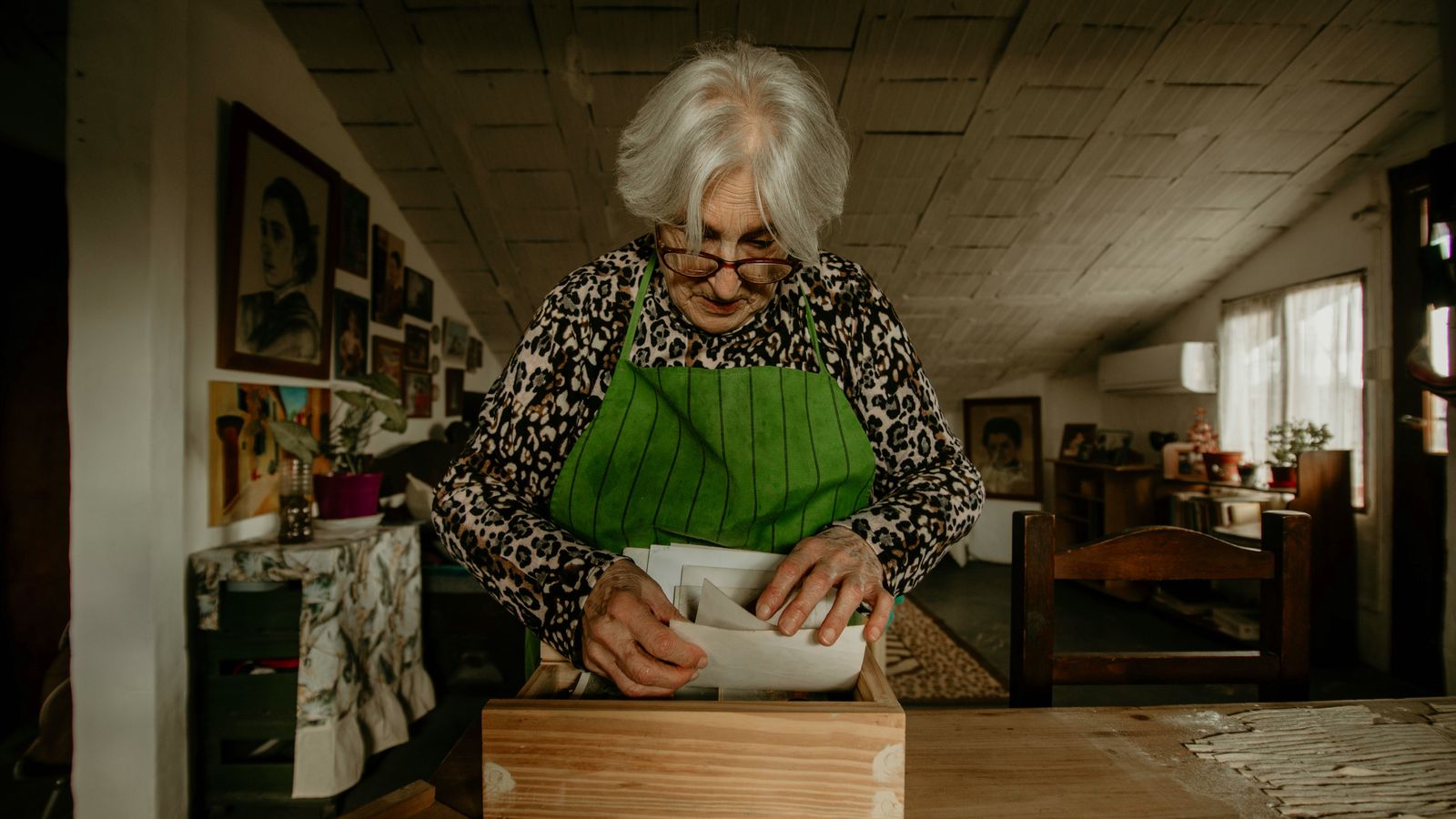 Home cook organizing recipe cards in a kitchen drawer near the stove