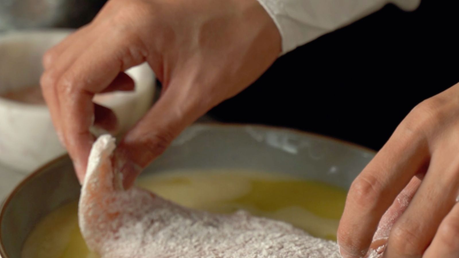 Breading station with flour, egg wash, and breadcrumbs prepared for air fryer cooking