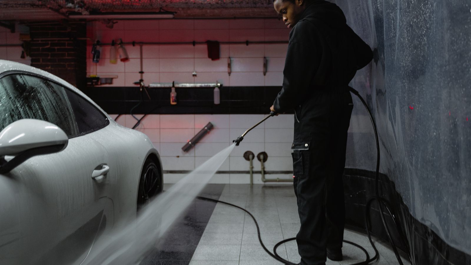 Commercial pressure steam cleaner spraying a driveway during an outdoor cleaning job