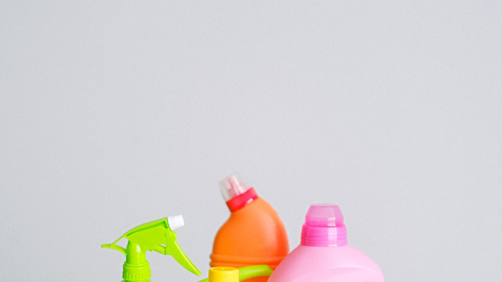 Bottles of concentrated cleaning chemicals arranged near a dilution mixing station