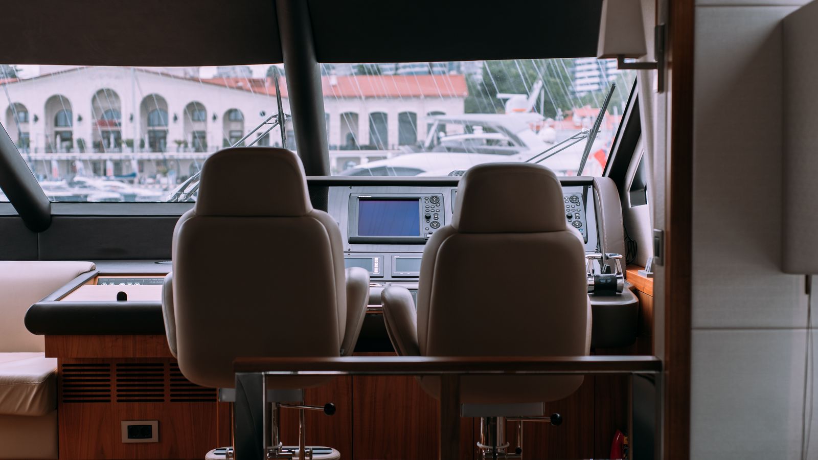 Boat interior seating area where a portable carpet cleaner is stored between trips