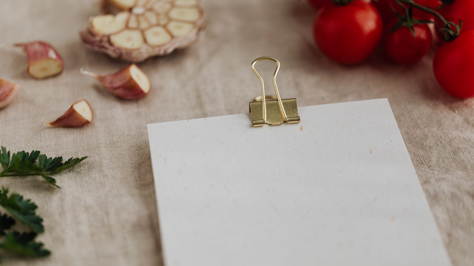 Recipe cards laid out on a kitchen counter next to cooking notes