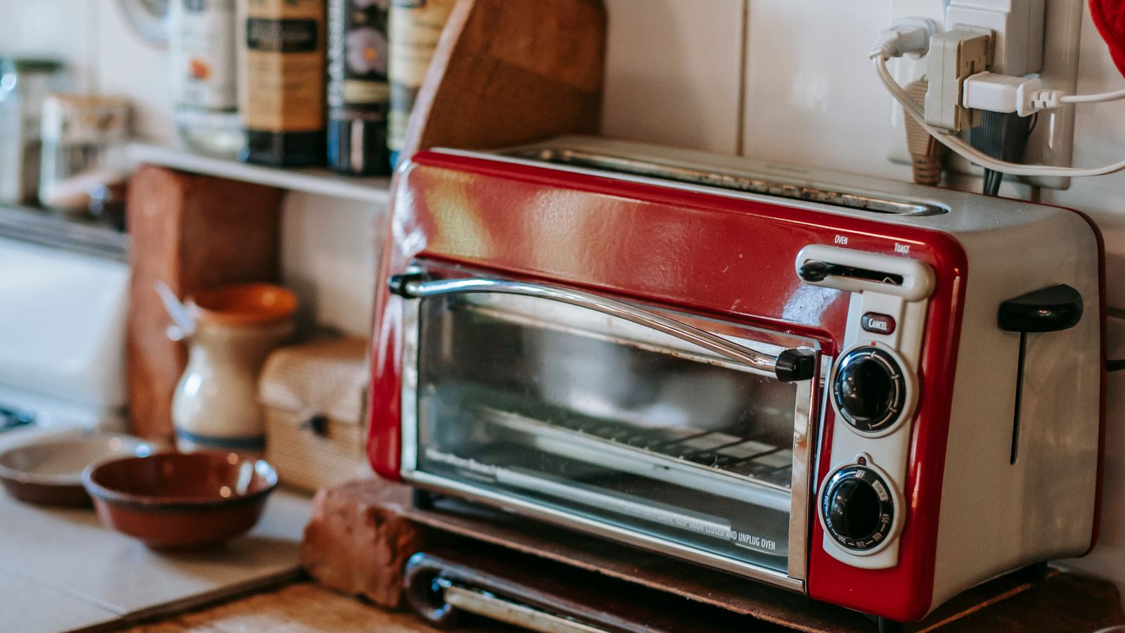 Kitchen counter with a toaster oven air fryer and other small appliances arranged for daily use