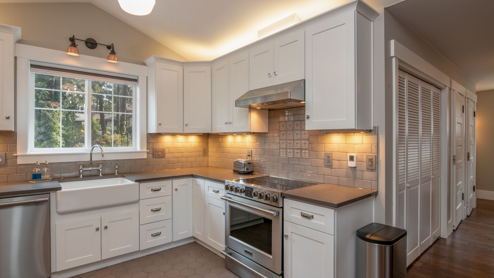 Bright kitchen with multiple countertop cooking appliances organized along the wall