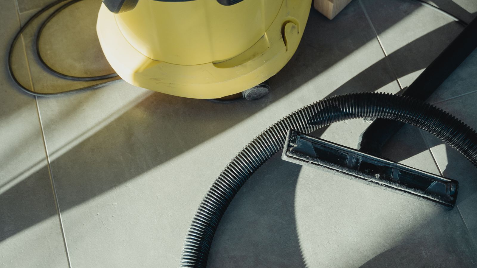 Commercial floor scrubber machine parked in a cleaning equipment staging area