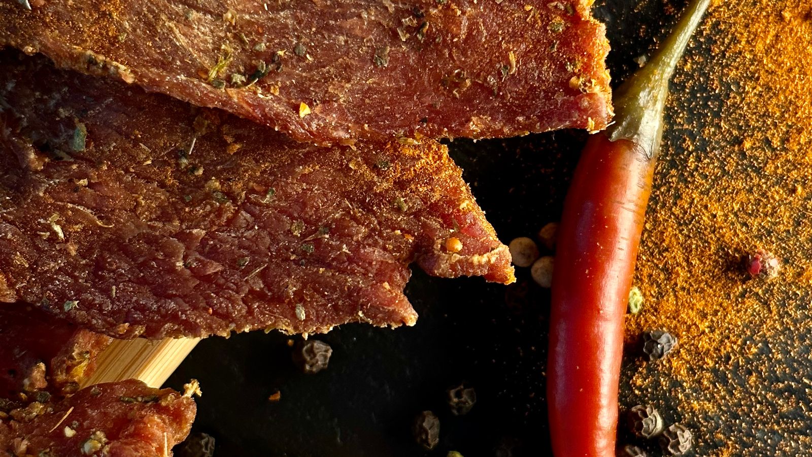 Strips of homemade beef jerky made in a compact air fryer basket