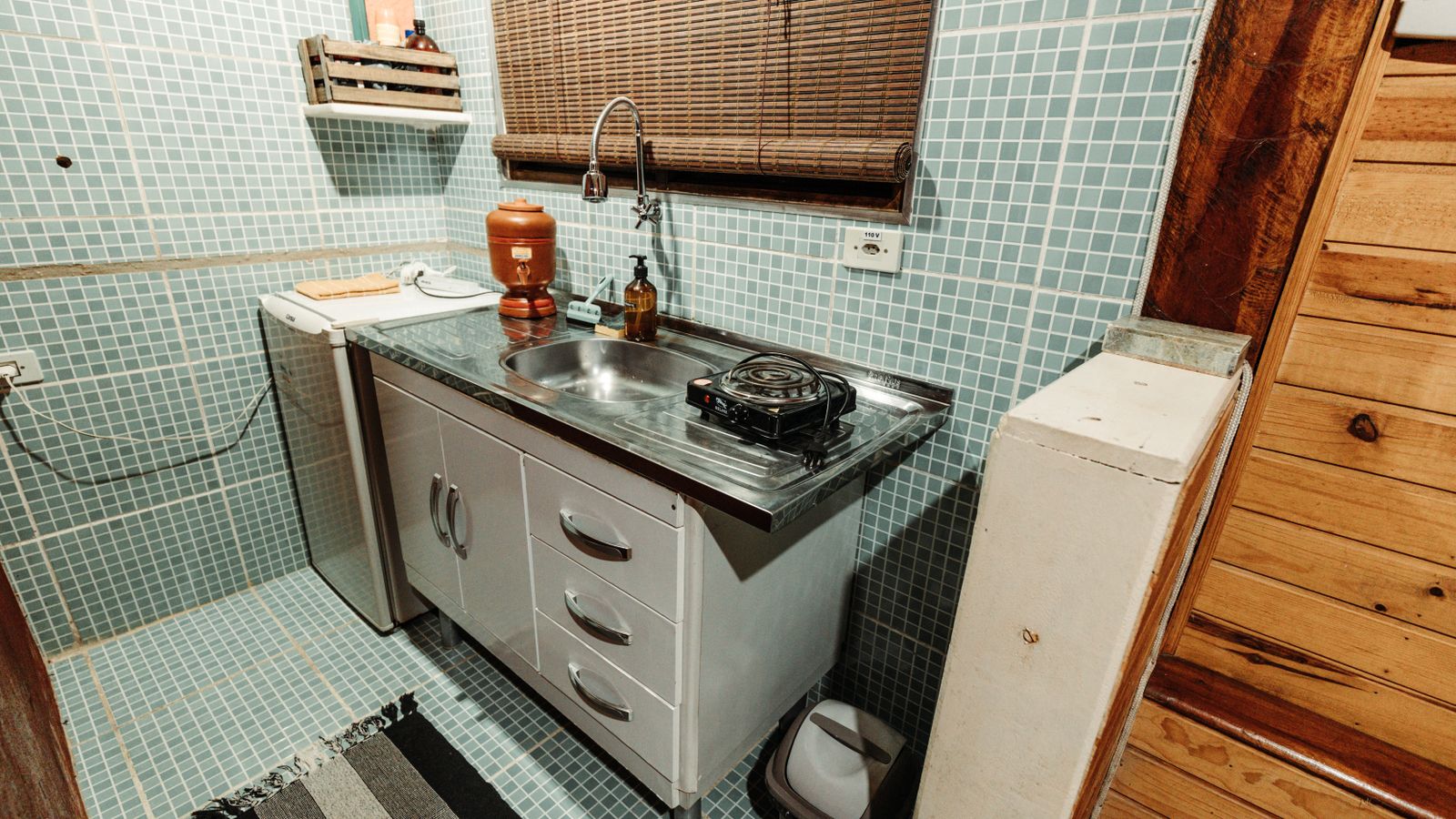 Compact small kitchen with limited cabinet and counter space near a gas stove