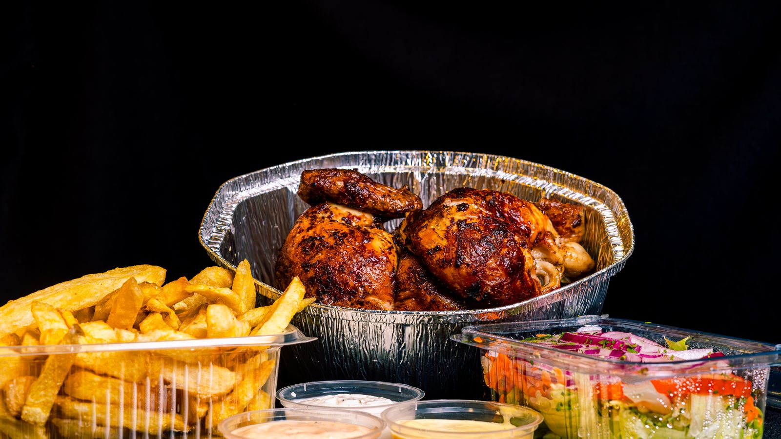 Golden rotisserie chicken resting inside a cylindrical basket accessory