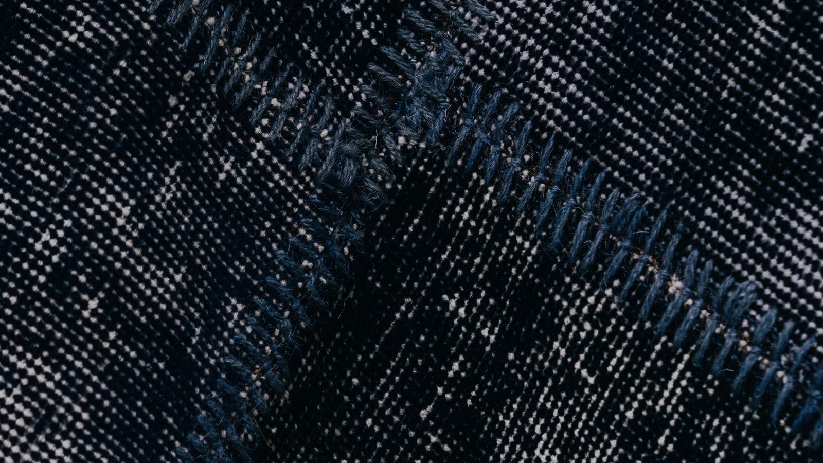 Close-up of carpet fibers and edge where repair tools are needed