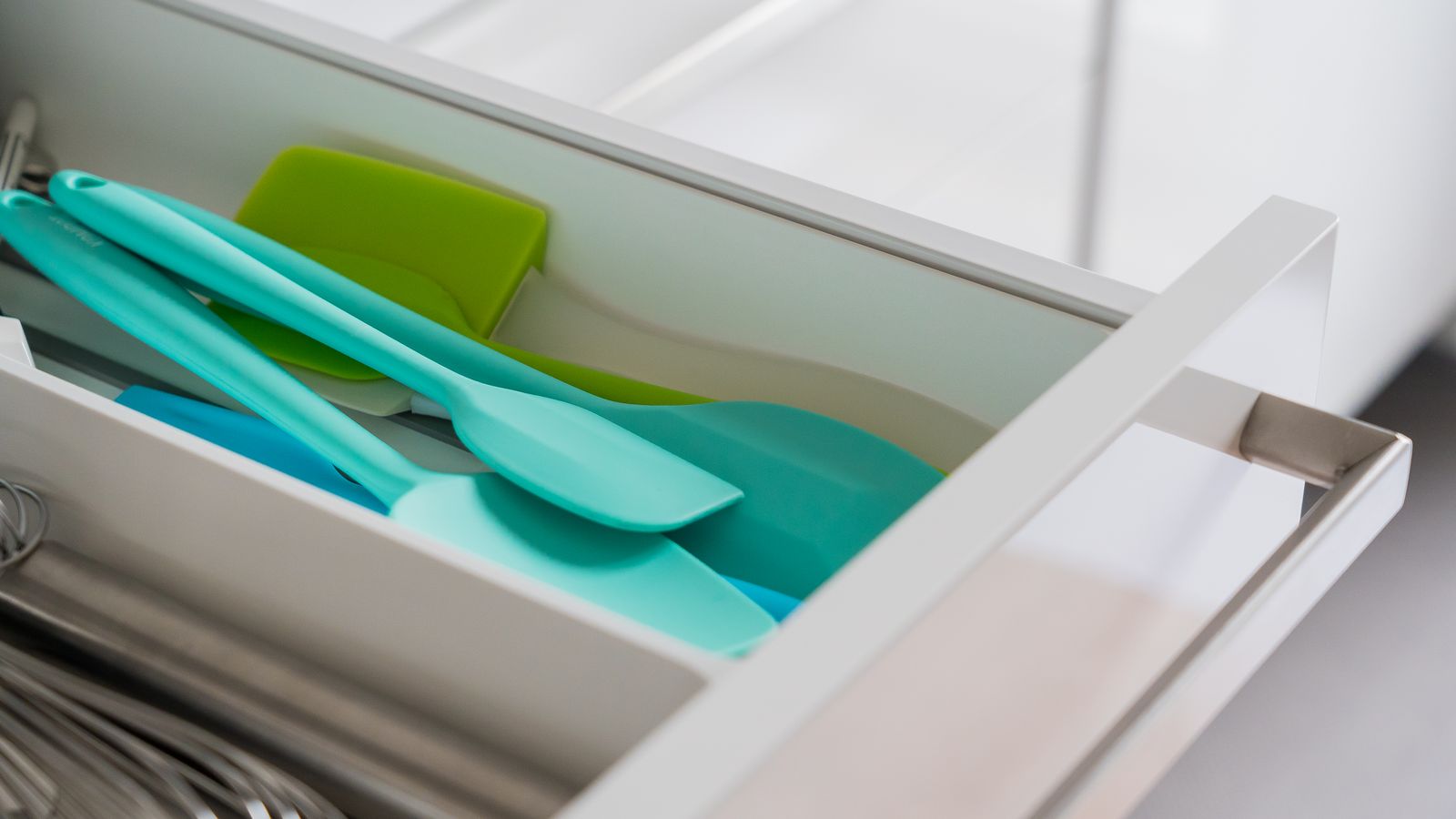 Organized kitchen drawer with silicone utensils and tools