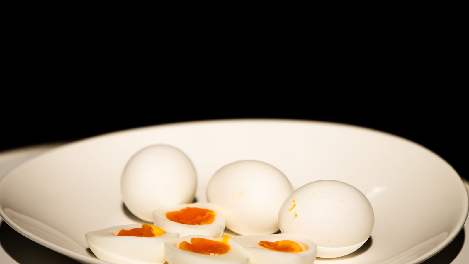 Sliced hard-boiled eggs on a plate after cooking in an air fryer