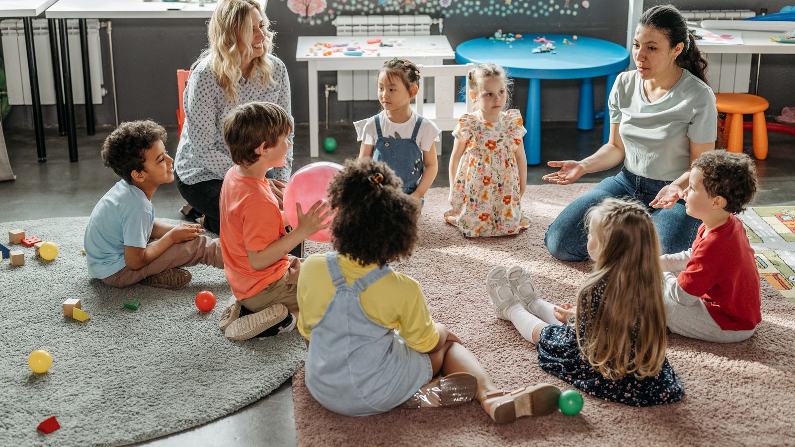 Colorful daycare classroom carpet with toys, showing an area that needs regular cleaning