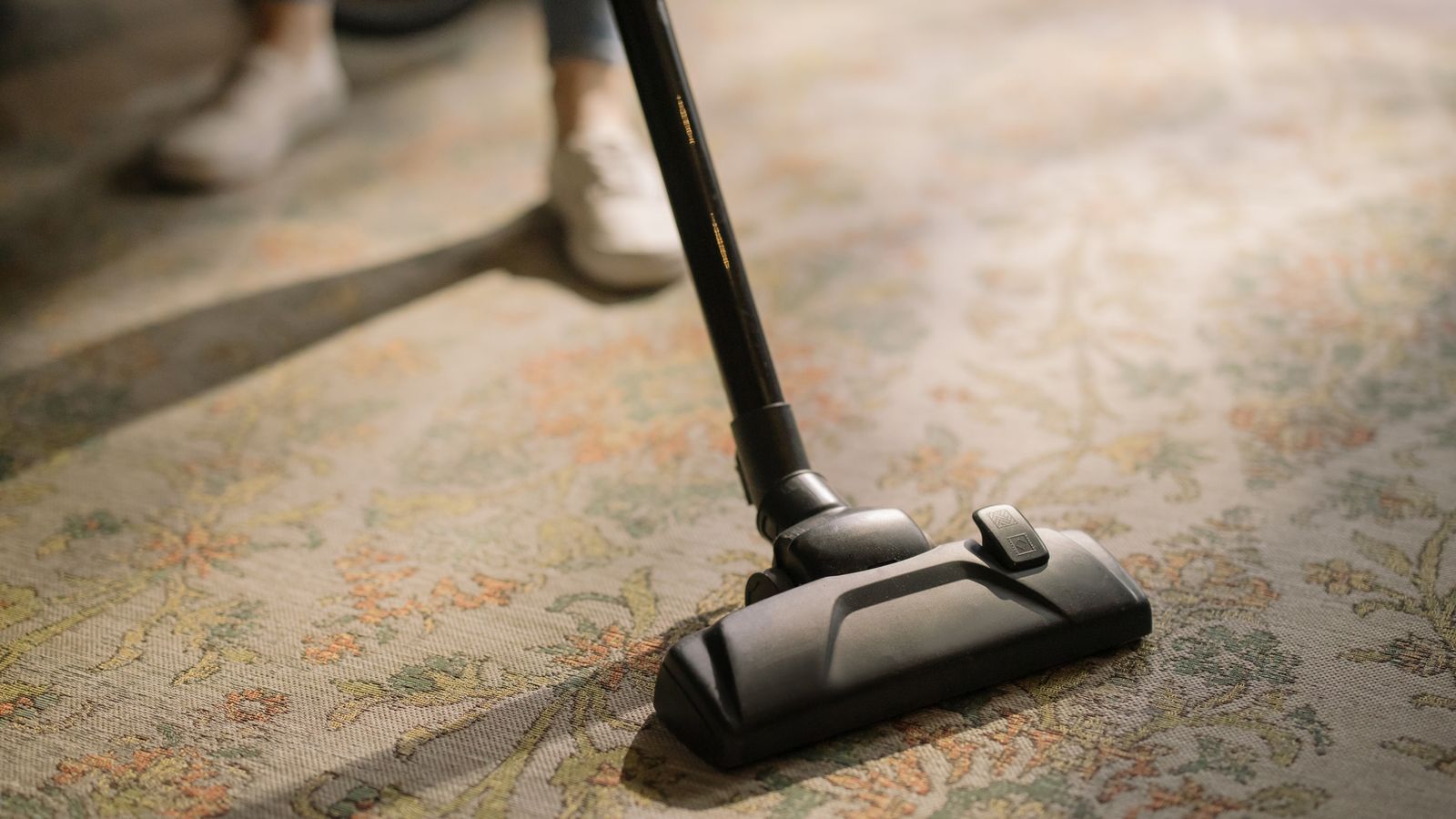Technician operating a truck mount carpet extractor hose on a commercial carpet job