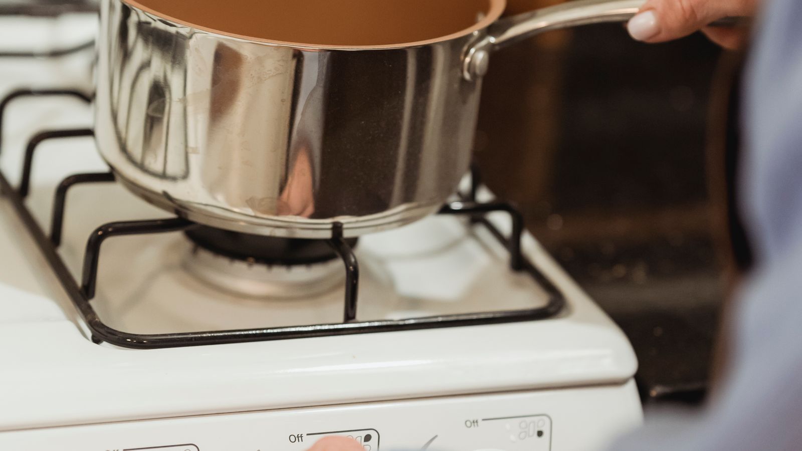 Saucepan simmering on a gas stove burner during home cooking