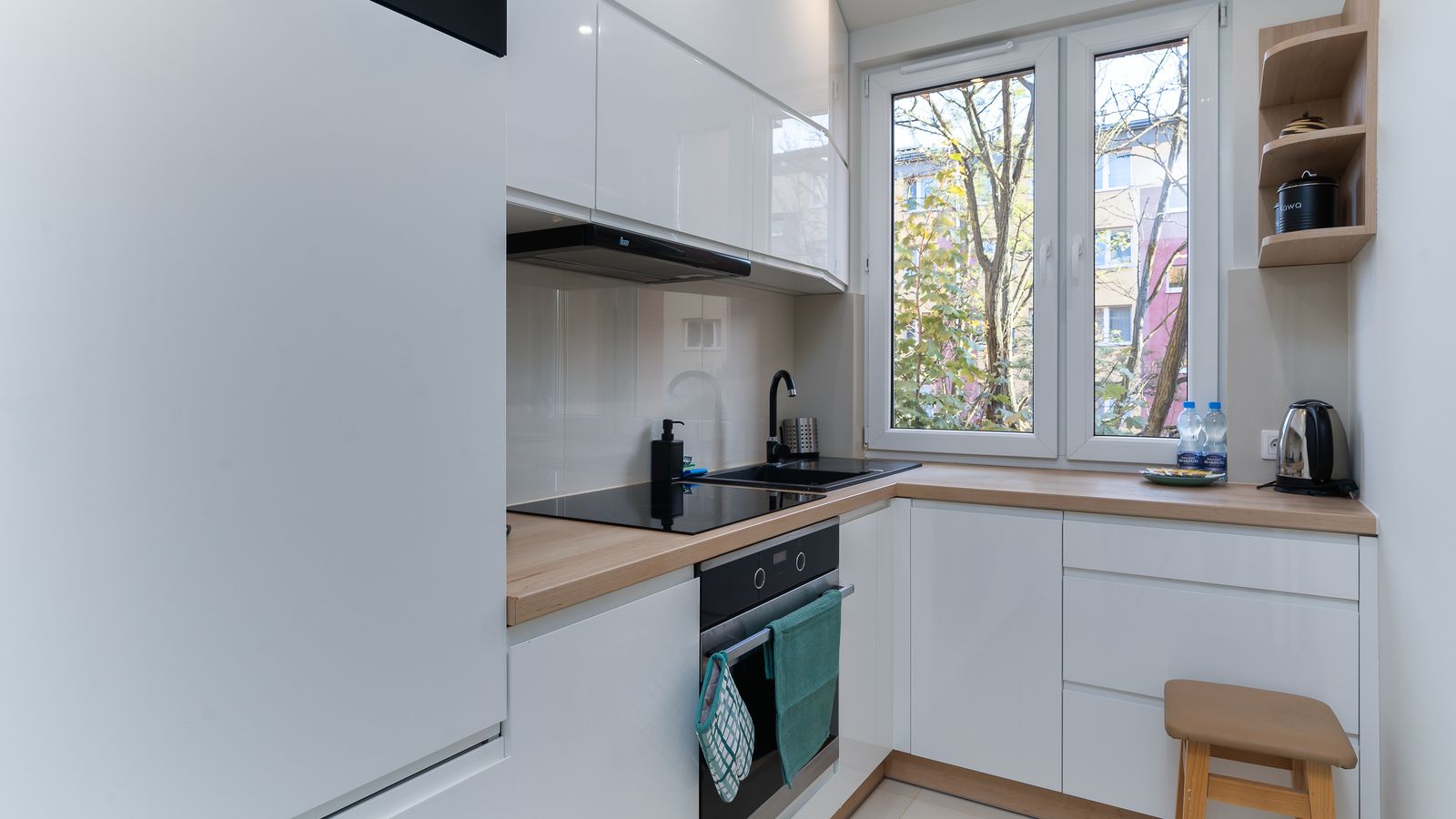 Small apartment kitchen with low overhead cabinets and limited counter space for an air fryer