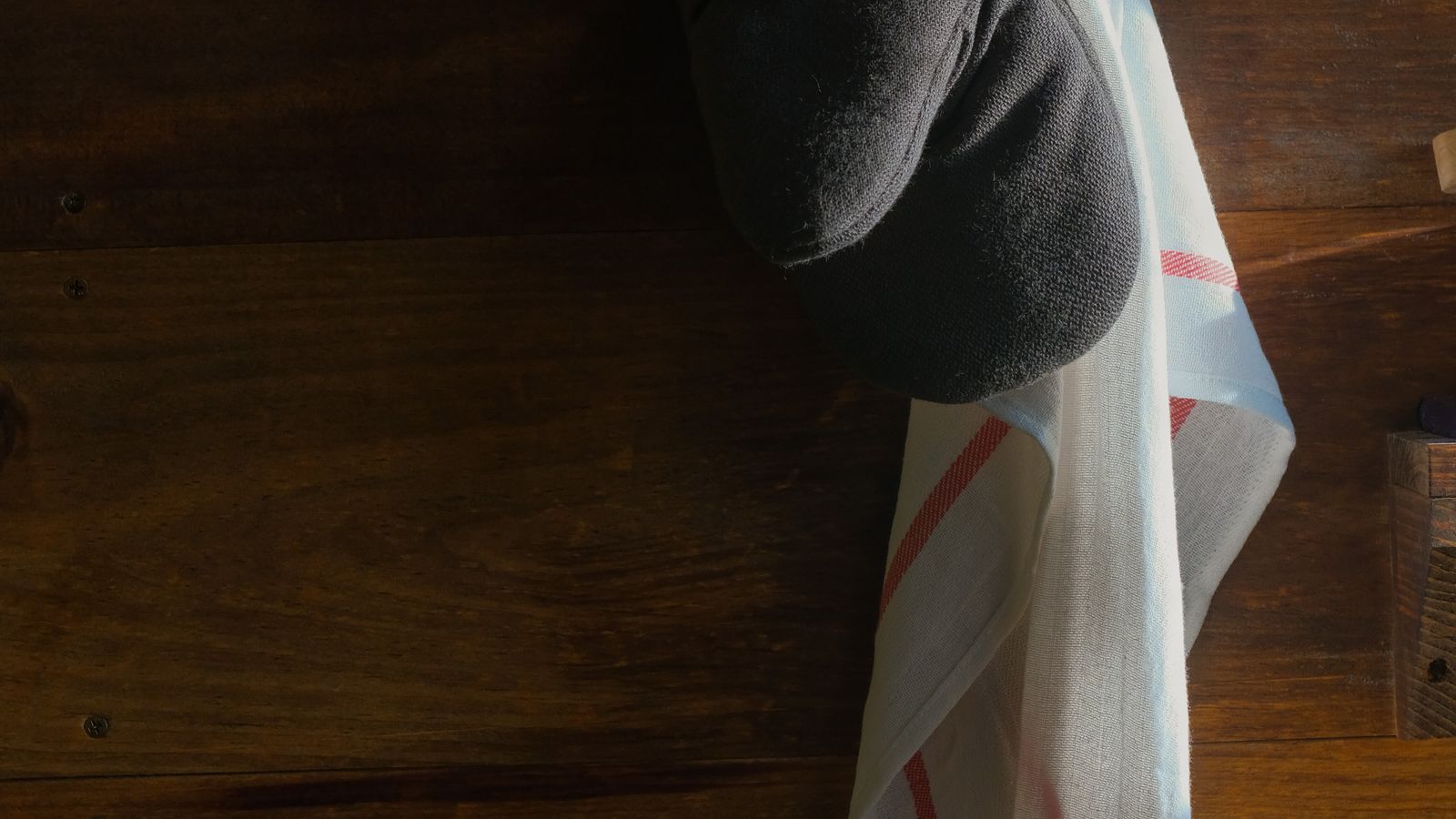 Folded pot holder set placed near a countertop cooking station for quick access