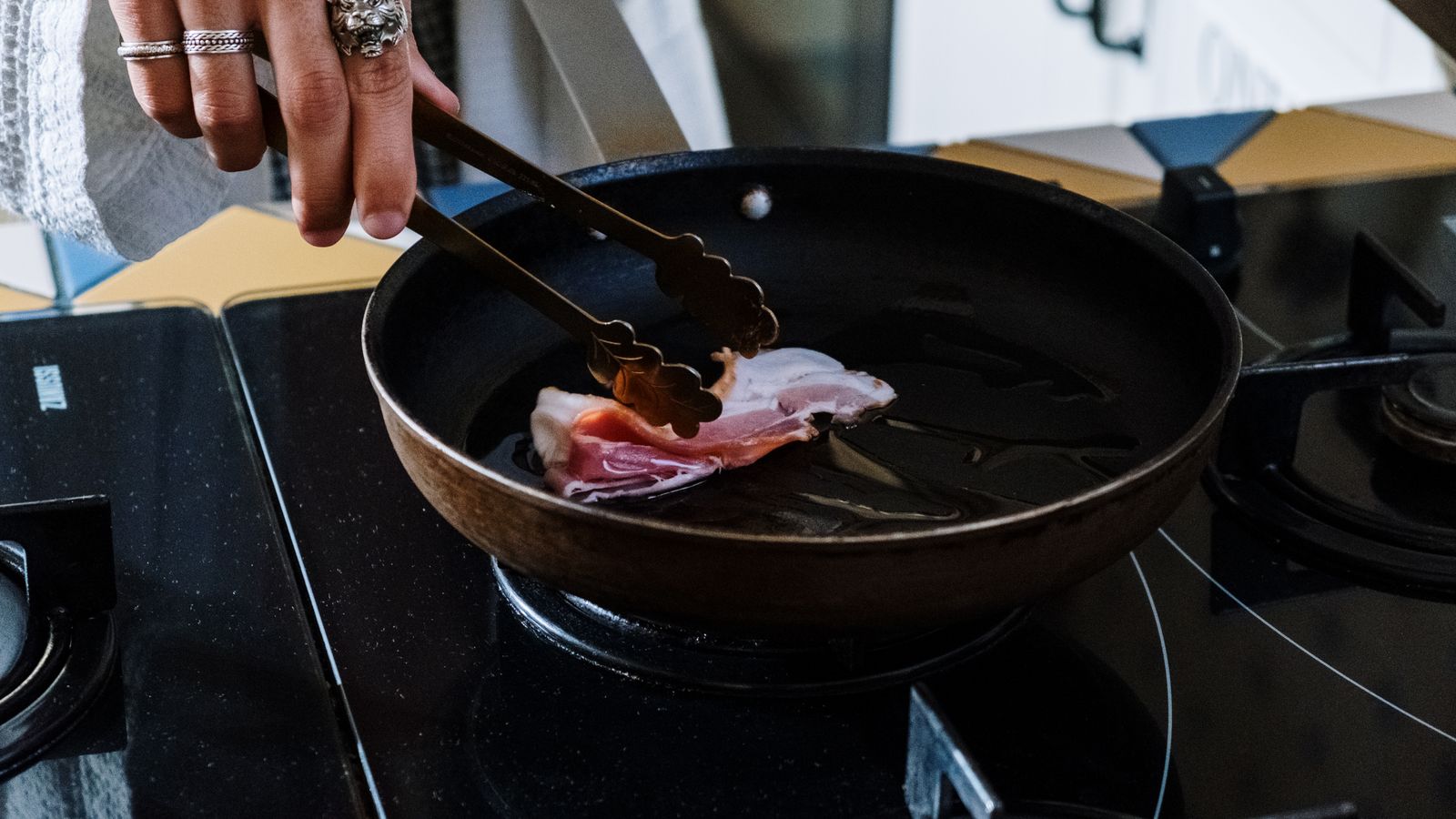 Kitchen tongs used to handle crispy air fried frozen snacks