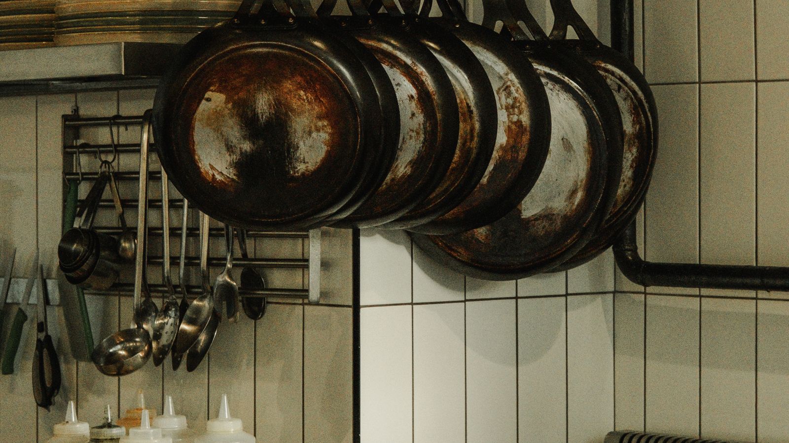 Kitchen cookware and accessories hanging in an organized storage area
