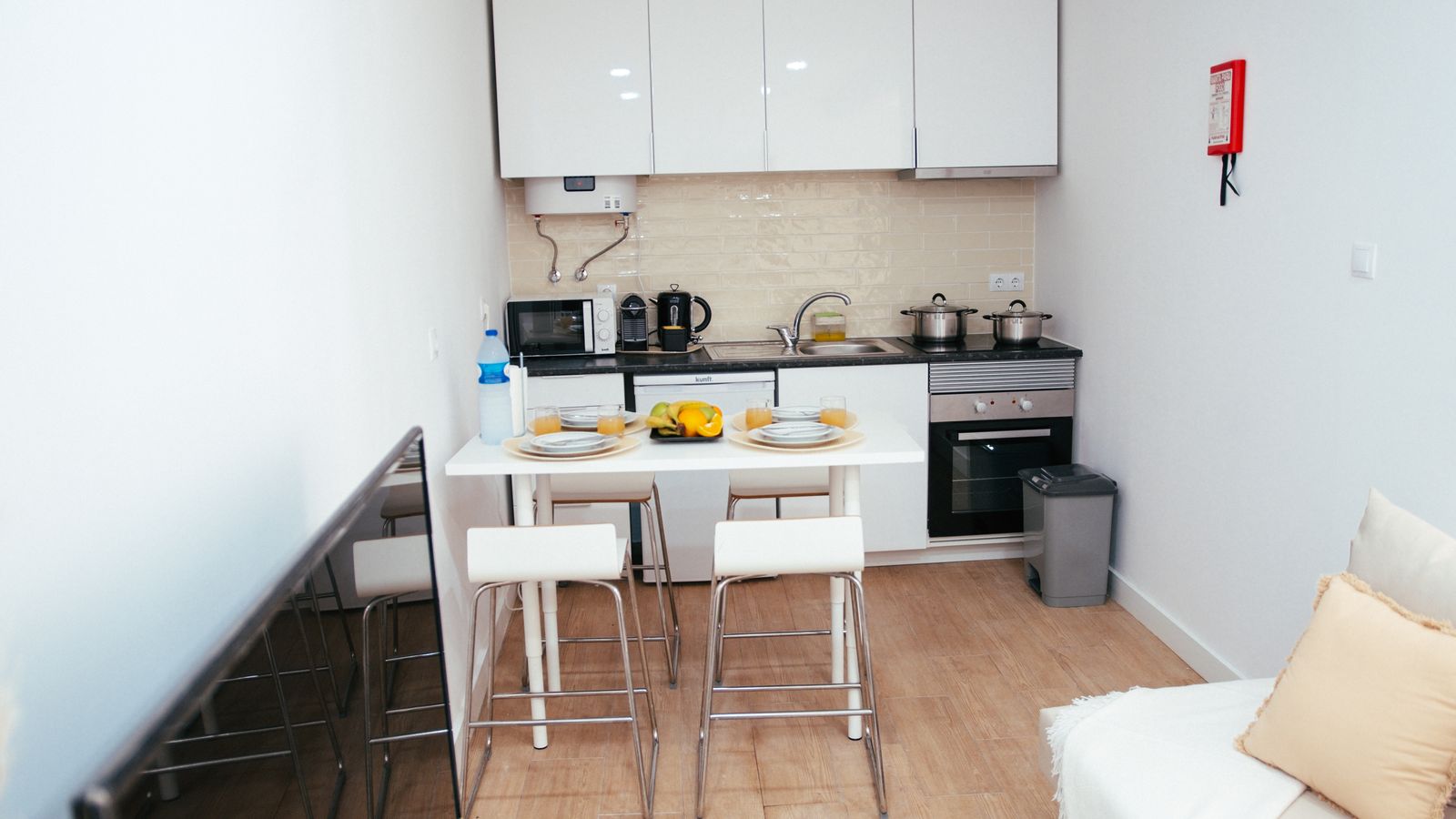 Compact air fryer stored on a small kitchen counter in a student apartment