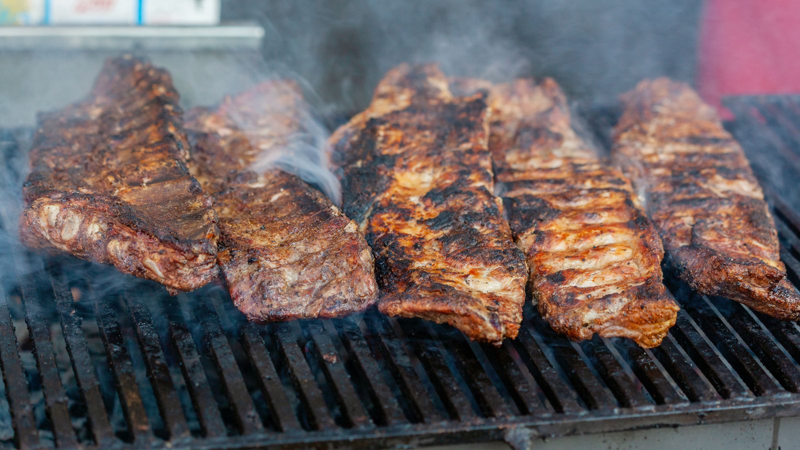 Rack of cooked ribs resting after coming out of an air fryer basket
