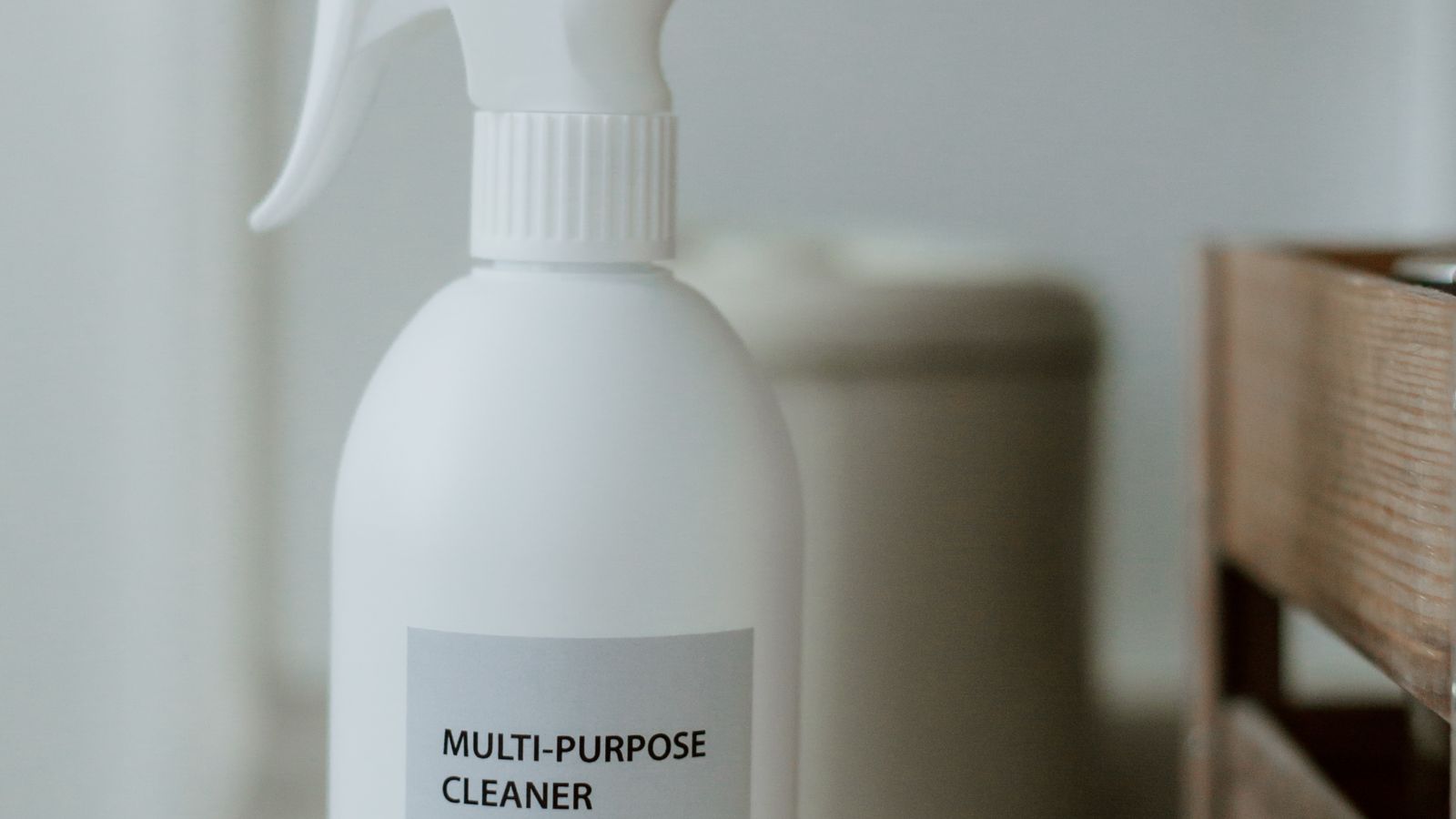 Spray bottle of carpet cleaning solution stored on a bathroom shelf