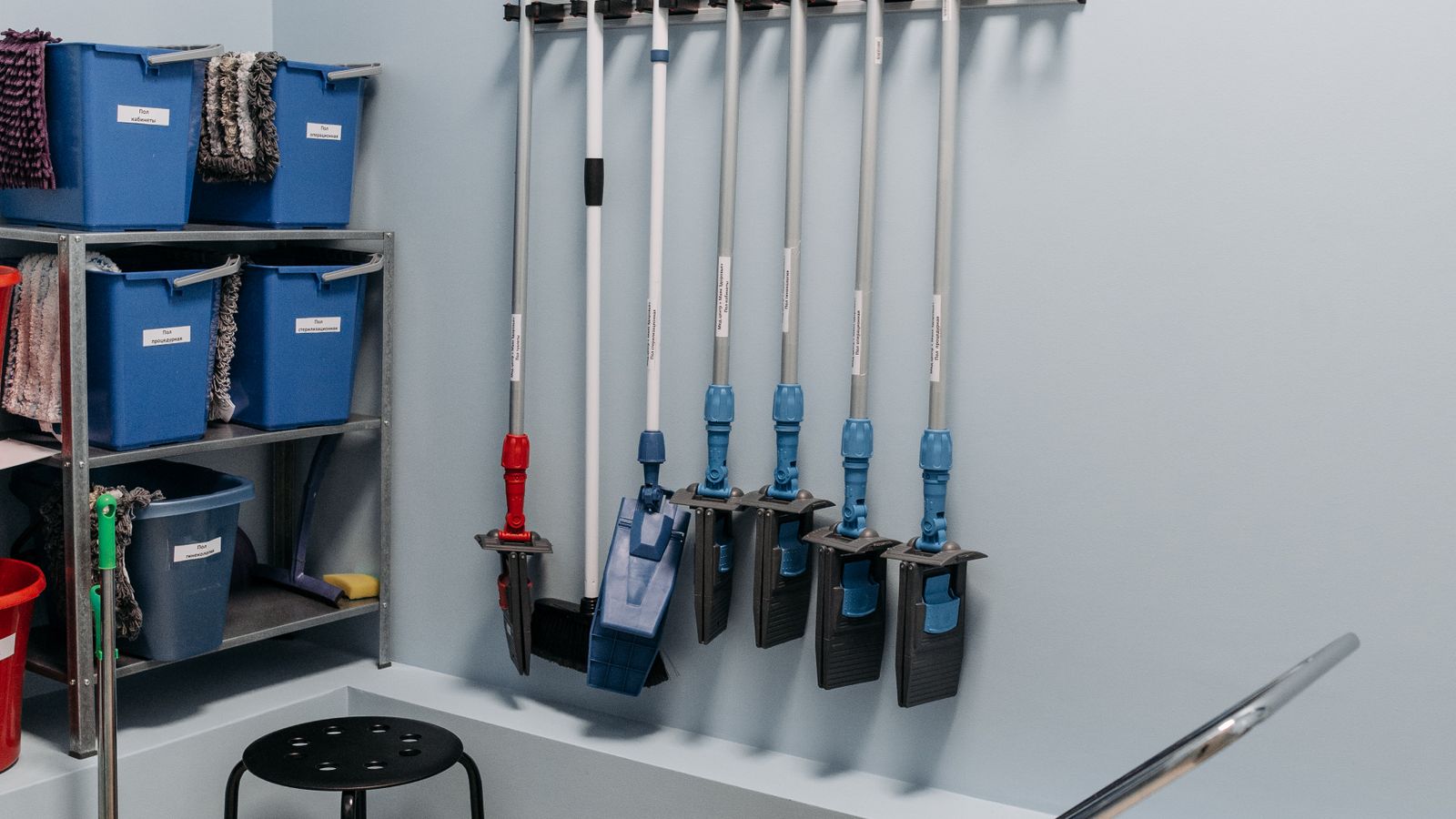 Organized storage shelf holding cleaning and inspection equipment cases in a workshop
