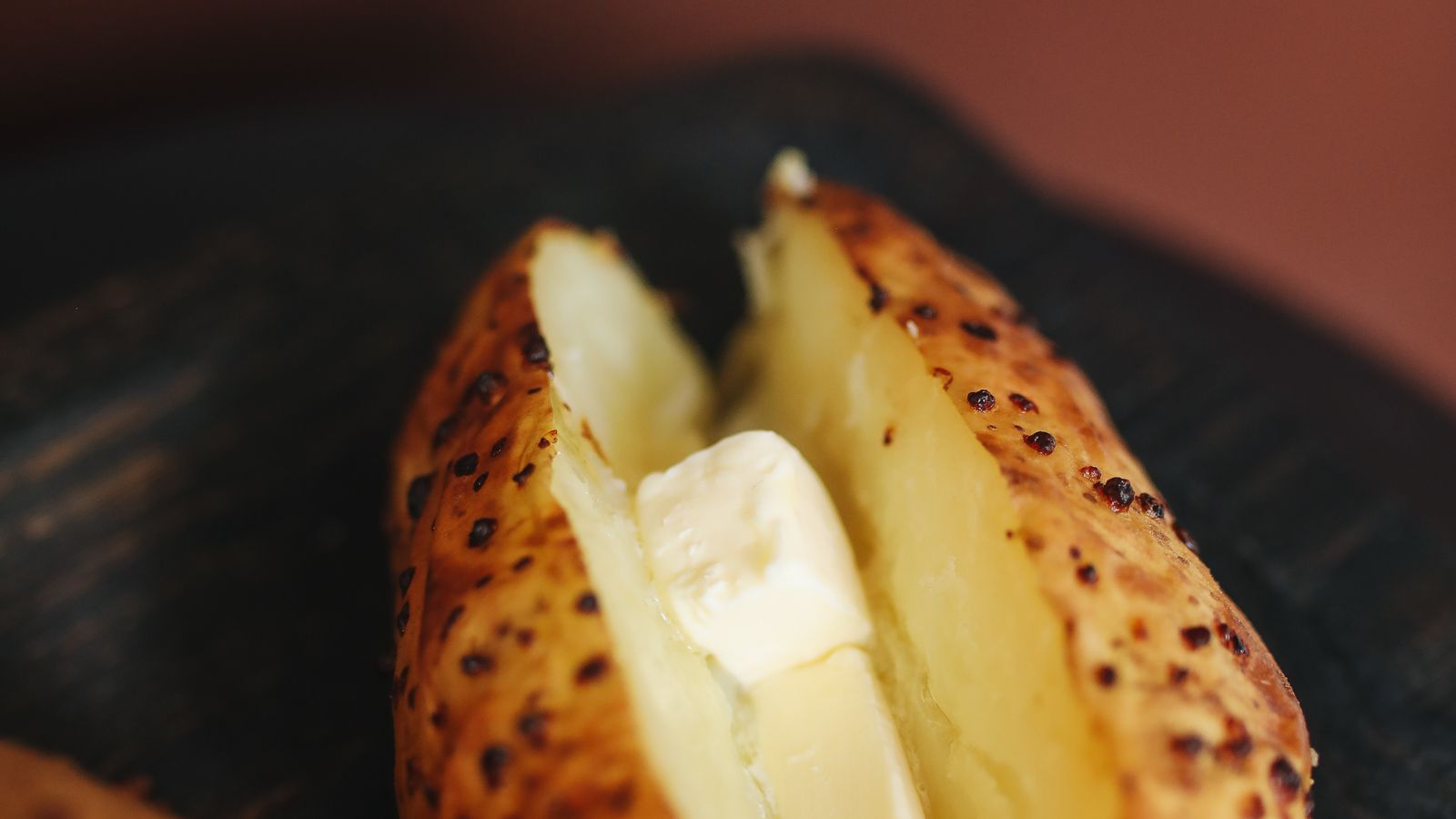 Whole baked potato with crisp skin fresh out of the air fryer