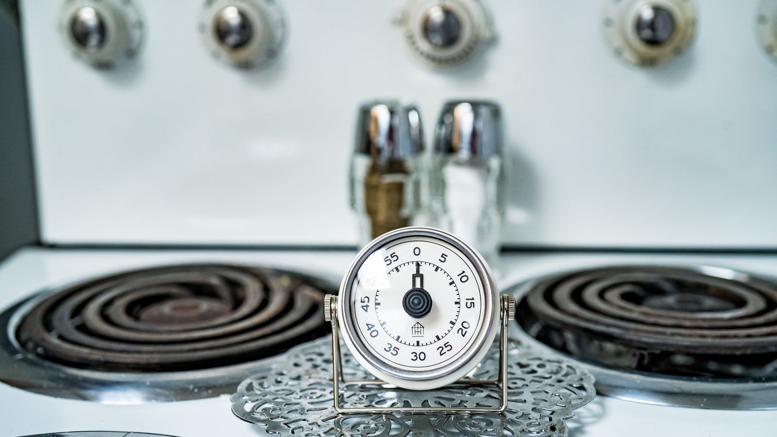 Kitchen timer magnet attached to a refrigerator door for tracking cook times