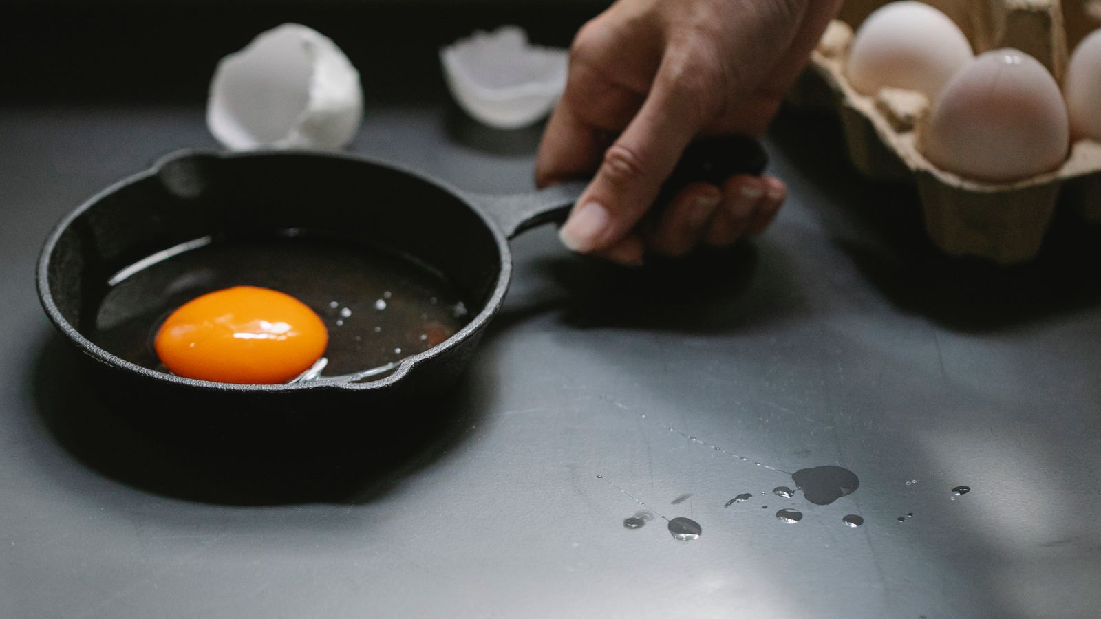 Seasoned cast iron skillet resting on a stovetop burner